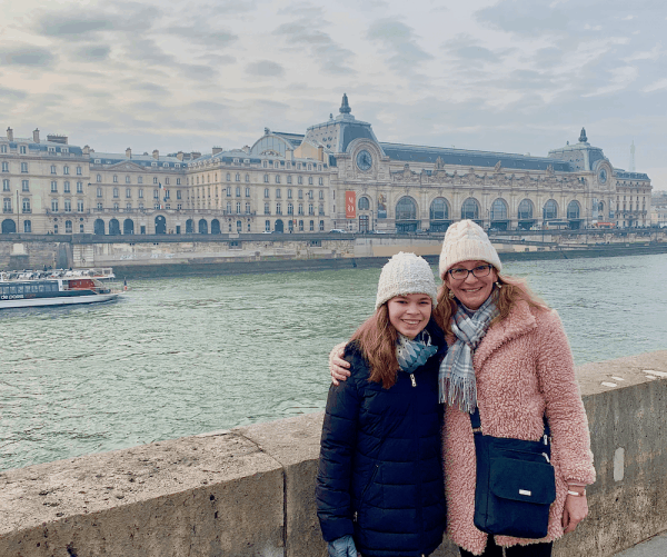 Mother and daughter posing for a picture at lake view