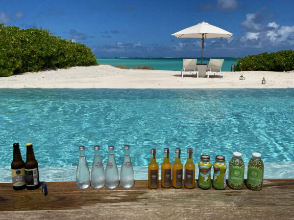 beverages lined up on the side of a pool