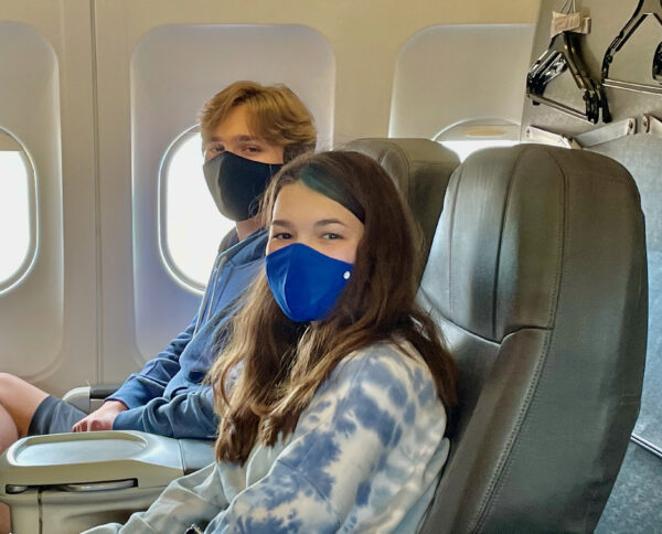passengers wearing masks on a plane