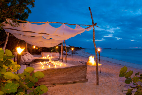 a beach cabana with a bonfire