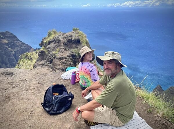 Enjoying the views over a cliff in Kauai